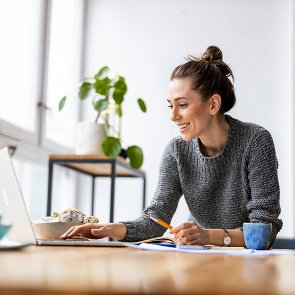 Woman smiling while using her laptop