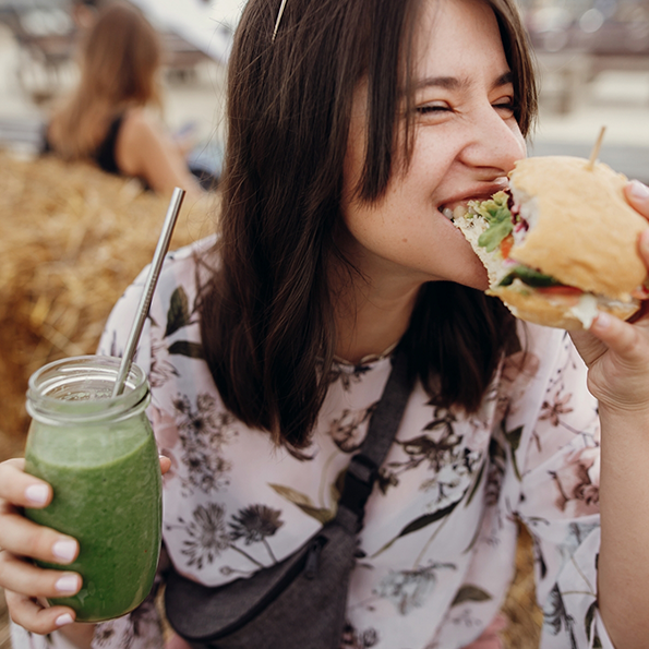 Woman biting into a burger