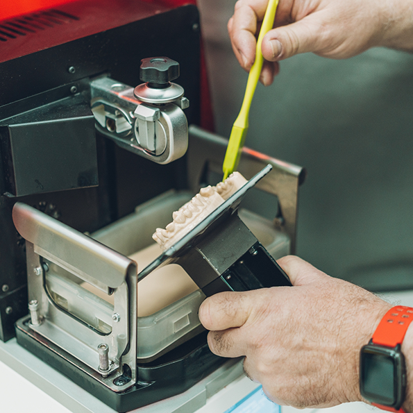 Dentist using a 3 D printer to create a denture