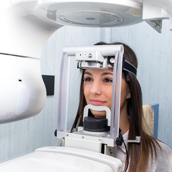 Young woman getting a C T cone beam scan of her mouth and jaw