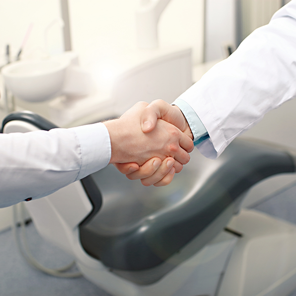 Person shaking hands with their dentist