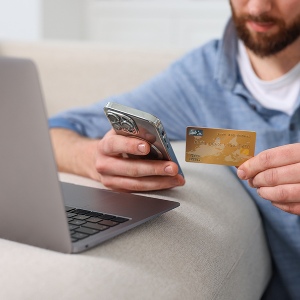 Person entering their credit card information onto their laptop