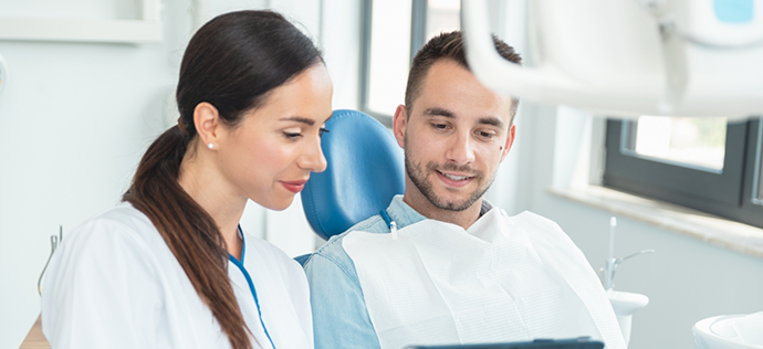 Dentist talking to a patient about replacing missing teeth in Warrenton