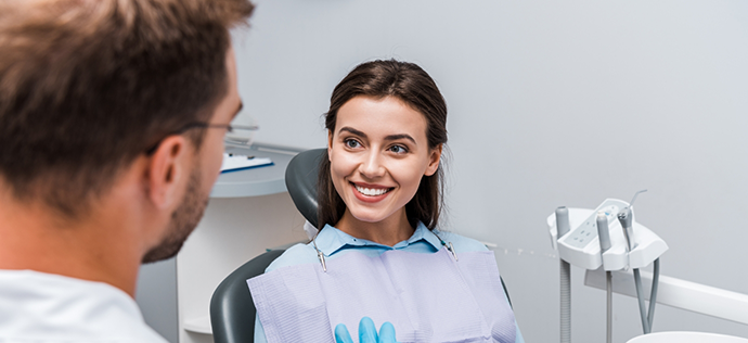 Young woman smiling at her dentist during a preventive dentistry checkup