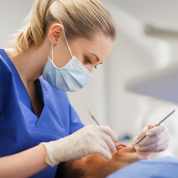 Dental hygienist giving a patient a teeth cleaning